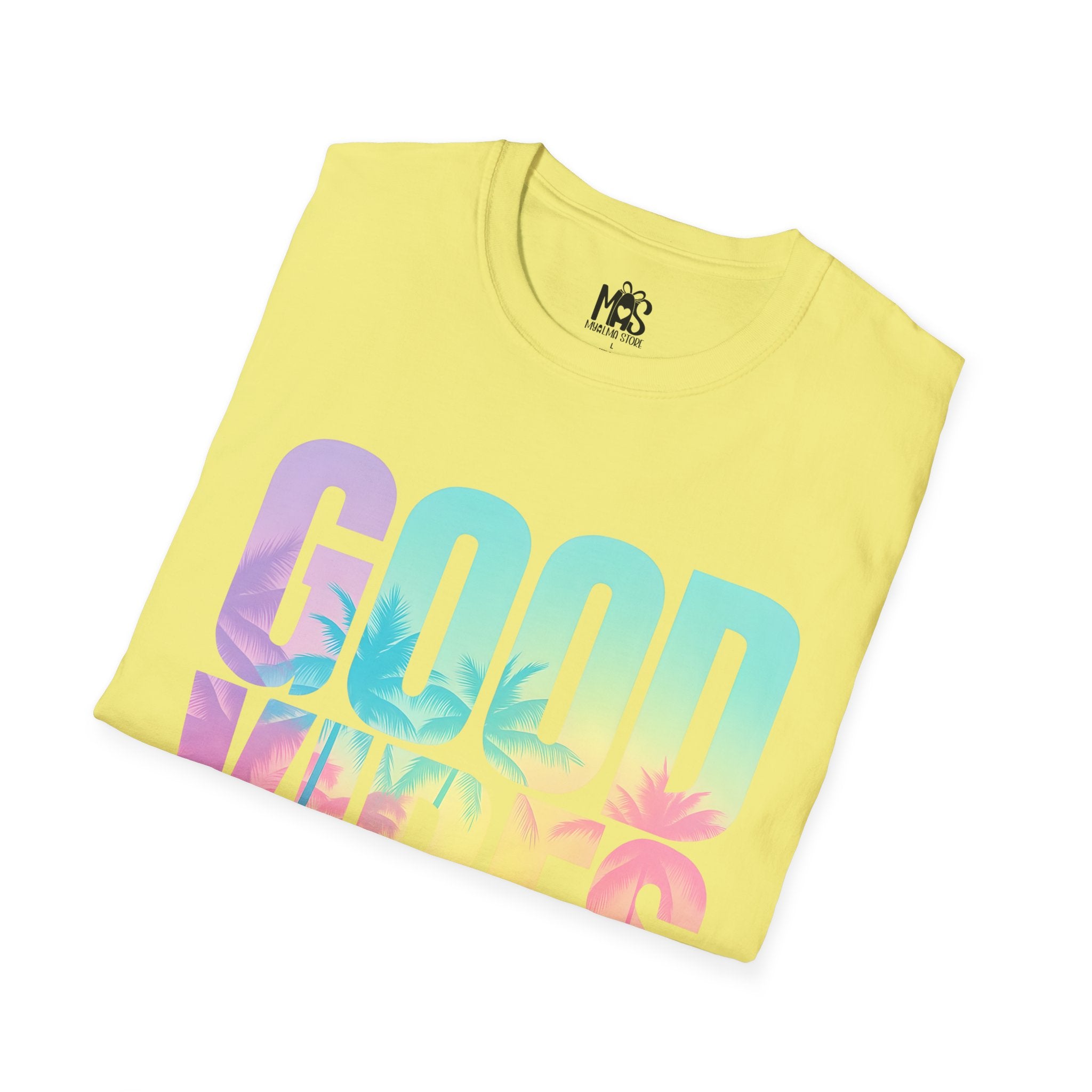 White folded shirt with pastel “Good Vibes” print / Camiseta blanca doblada con diseño pastel “Good Vibes”