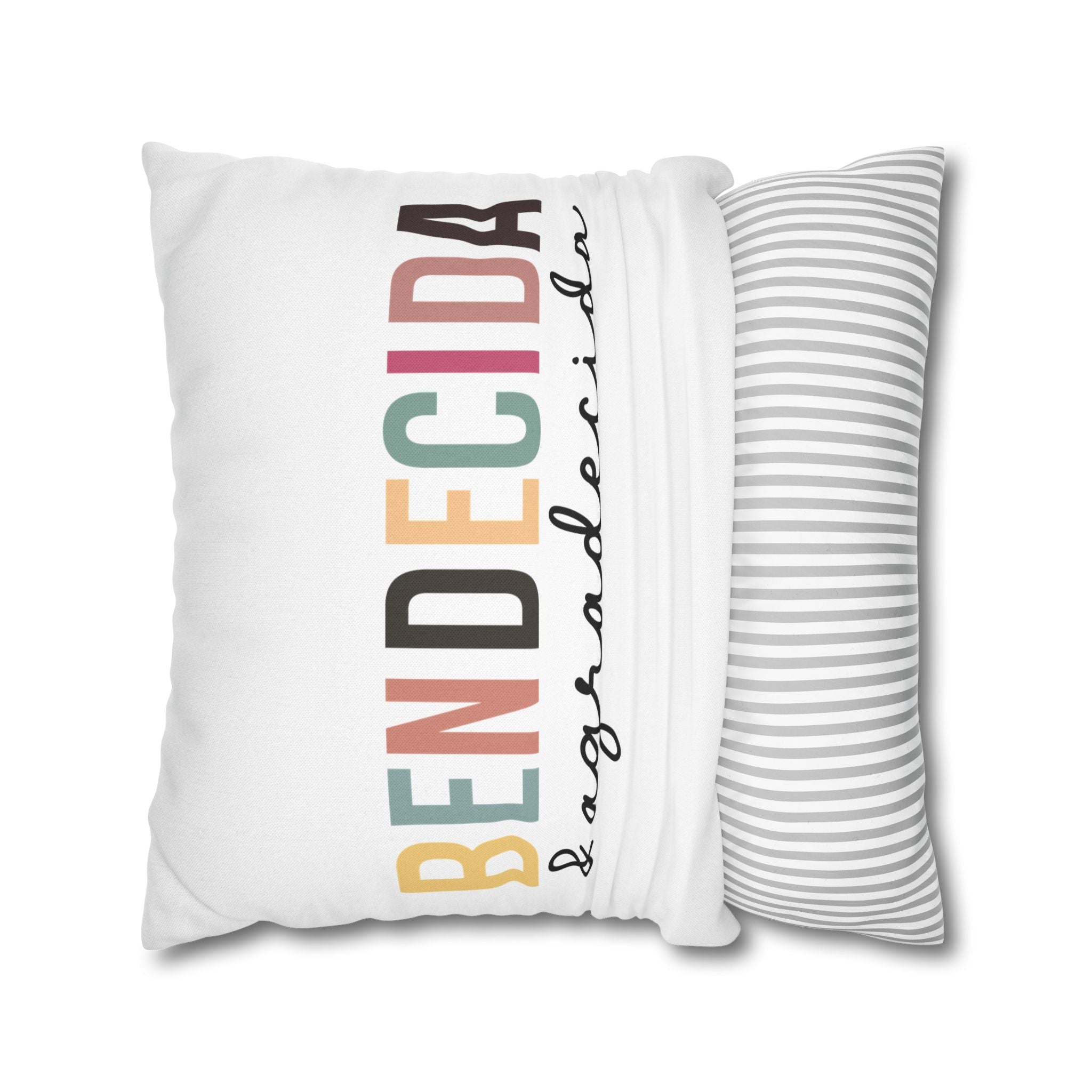 Personalized pillow cover with the word 'Bendecida' in colorful letters on a white background, paired with a striped design.